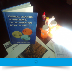 chemical cleaning hard back book with a blue cover sitting on a table with other papers and chemical bottles
